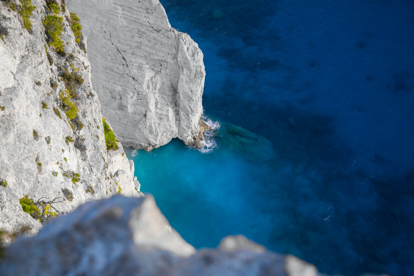 white and green cliff beside ocean